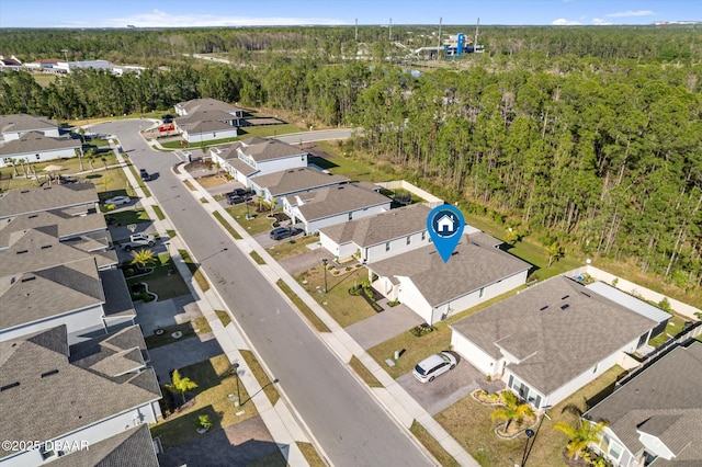 bird's eye view with a residential view and a wooded view