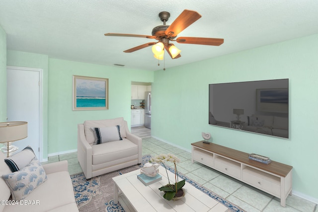 tiled living room featuring a textured ceiling and ceiling fan