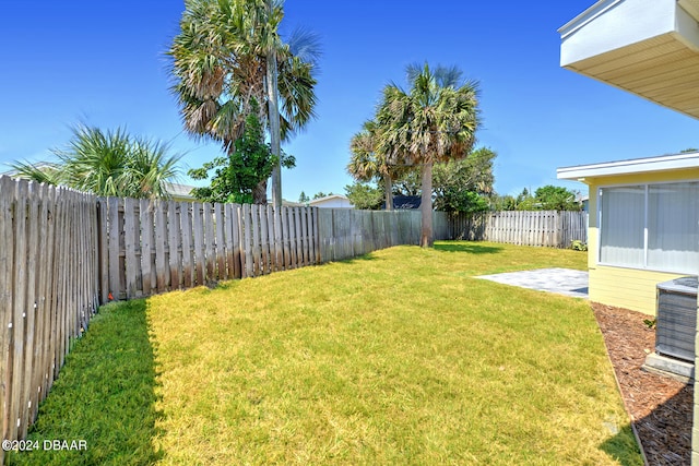 view of yard featuring central air condition unit and a patio area