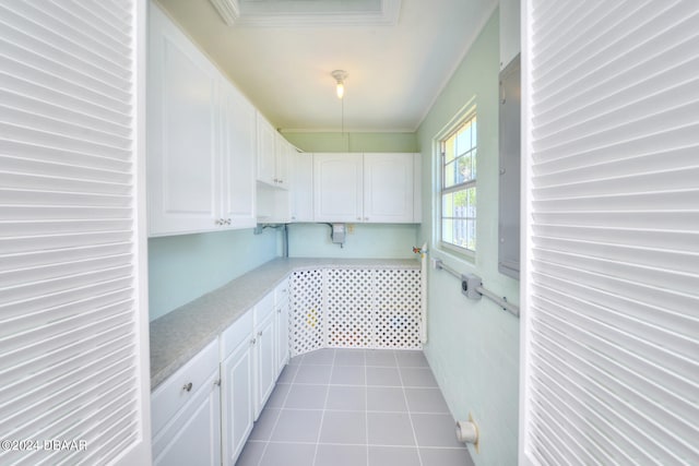 washroom with light tile patterned floors and crown molding