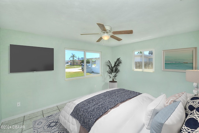 bedroom featuring ceiling fan and light tile patterned flooring