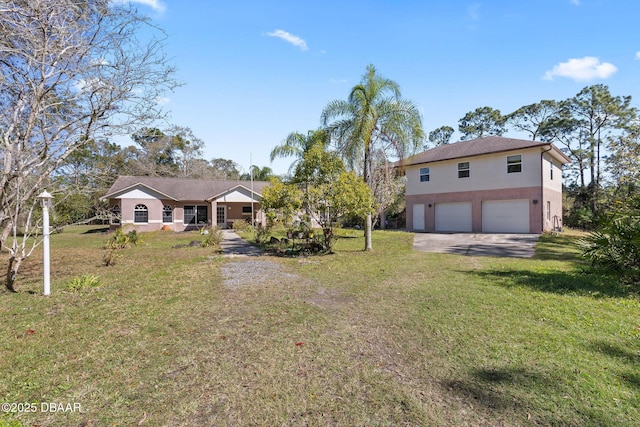 3531 Red Barn Ln, Ormond Beach, FL 32174 - view of front of home with stucco siding, an attached garage, a front yard, and driveway