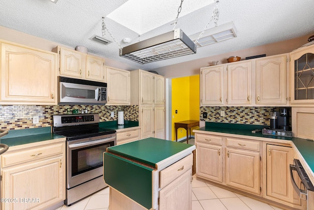 3531 Red Barn Ln, Ormond Beach, FL 32174 - kitchen featuring appliances with stainless steel finishes, light brown cabinets, light tile patterned floors, and a textured ceiling