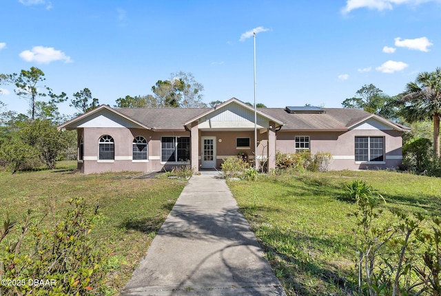 3531 Red Barn Ln, Ormond Beach, FL 32174 - ranch-style house featuring a front yard, stucco siding, and solar panels