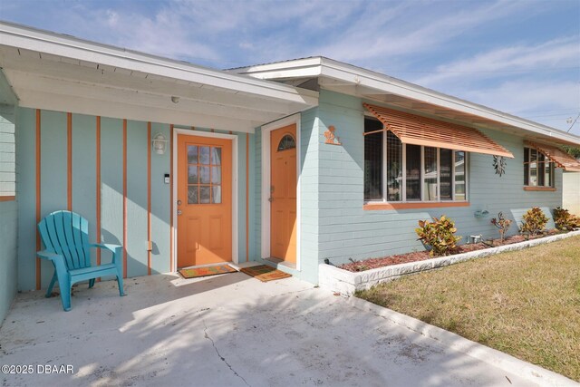 7 Azalea Dr, Ormond Beach, FL 32176 - view of exterior entry featuring concrete block siding