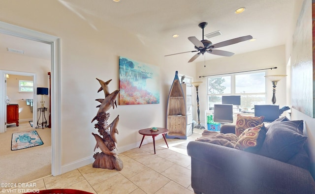 living room with ceiling fan, plenty of natural light, and light tile patterned floors