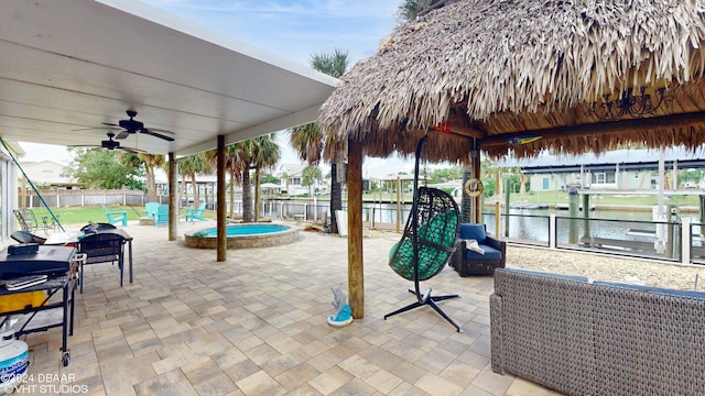 view of patio featuring a water view and ceiling fan