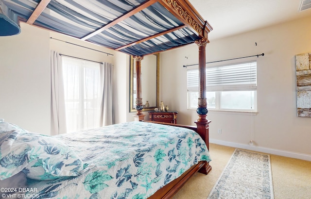 carpeted bedroom with ornate columns