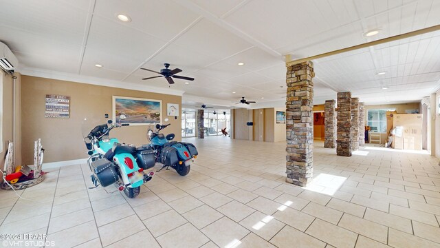 interior space featuring light tile patterned floors, crown molding, decorative columns, and ceiling fan