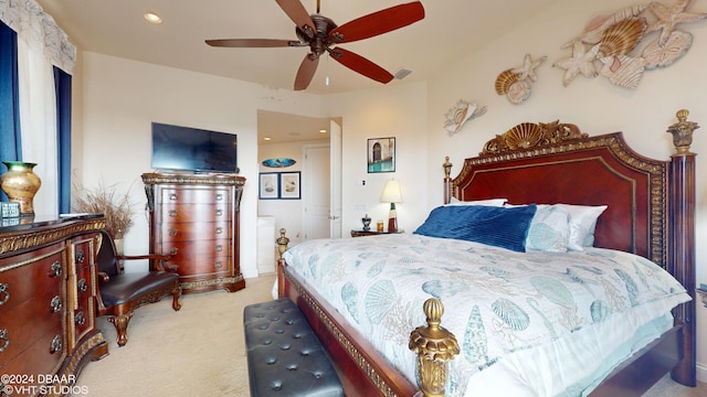 bedroom featuring light colored carpet and ceiling fan