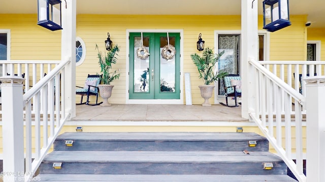 property entrance featuring french doors and covered porch