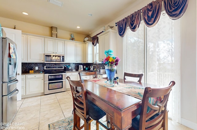 tiled dining room featuring plenty of natural light