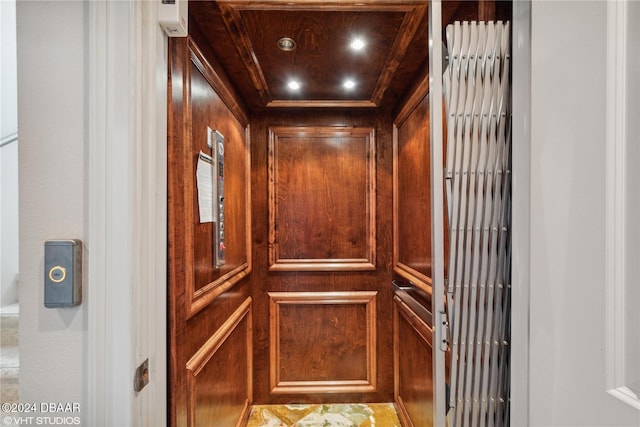 interior details featuring elevator and wood walls