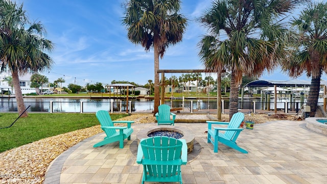 view of patio with a water view and a fire pit