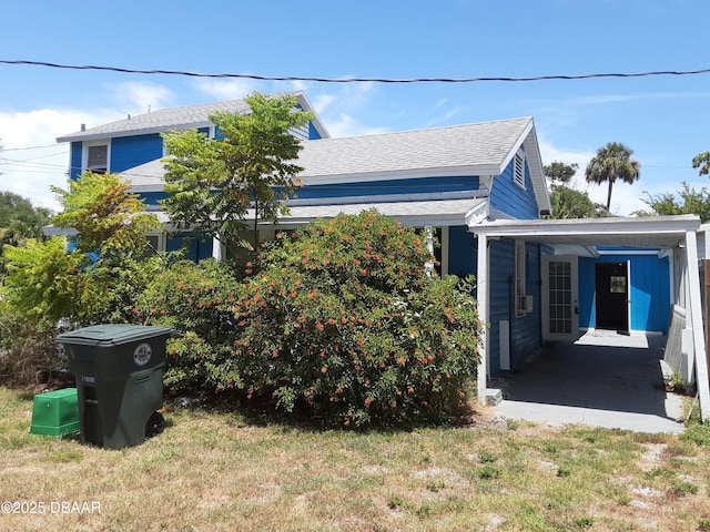 312 Frances Ter, Daytona Beach, FL 32118 - view of property exterior with roof with shingles and a carport