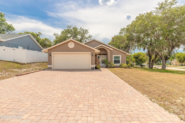 198 Heather Lane Dr, Deltona, FL 32738 - view of front of house featuring decorative driveway, a garage, and stucco siding