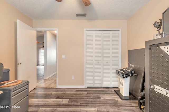 198 Heather Lane Dr, Deltona, FL 32738 - bedroom featuring wood finished floors, a closet, a textured ceiling, and ceiling fan