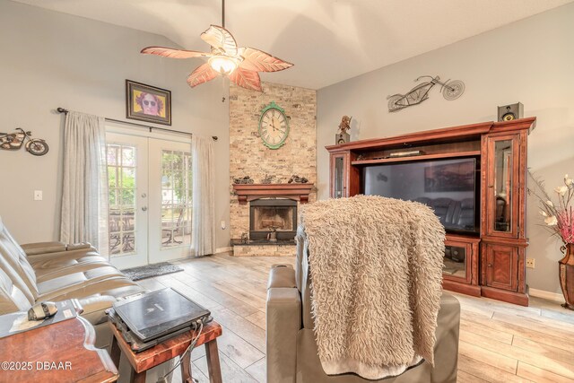 198 Heather Lane Dr, Deltona, FL 32738 - living room featuring light wood-style flooring, a ceiling fan, a fireplace, french doors, and high vaulted ceiling