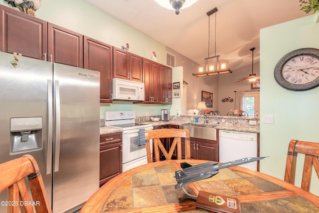 198 Heather Lane Dr, Deltona, FL 32738 - kitchen with white appliances, a ceiling fan, pendant lighting, and light stone finish flooring
