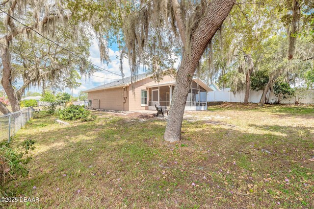 198 Heather Lane Dr, Deltona, FL 32738 - fenced backyard with a sunroom