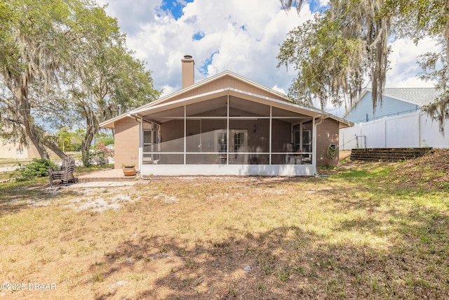 198 Heather Lane Dr, Deltona, FL 32738 - rear view of house featuring a sunroom and a chimney