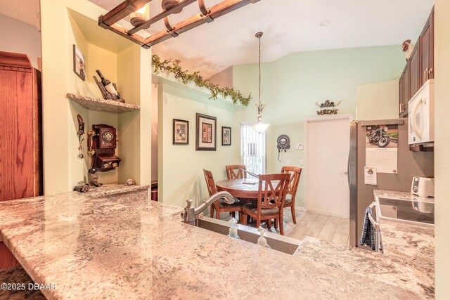 198 Heather Lane Dr, Deltona, FL 32738 - dining room with lofted ceiling and light wood-style floors