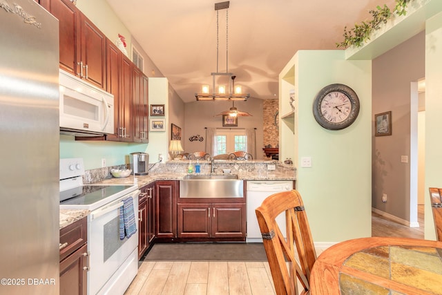 198 Heather Lane Dr, Deltona, FL 32738 - kitchen with white appliances, light wood finished floors, hanging light fixtures, and light stone counters