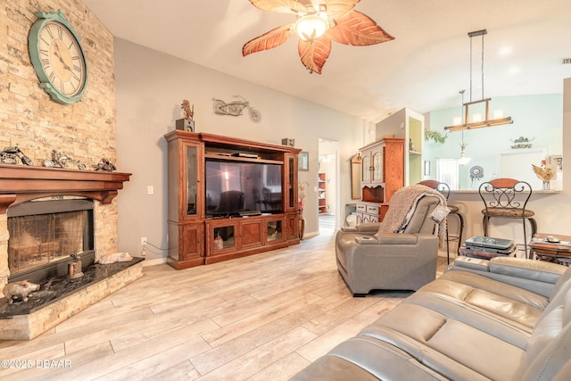 198 Heather Lane Dr, Deltona, FL 32738 - living area with a ceiling fan, light wood finished floors, a stone fireplace, lofted ceiling, and a chandelier