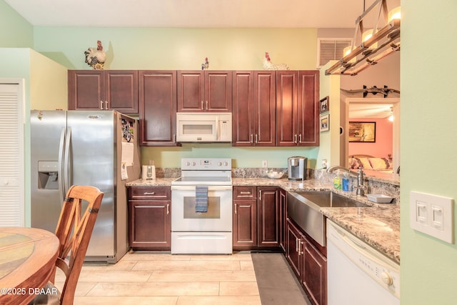 198 Heather Lane Dr, Deltona, FL 32738 - kitchen with white appliances, wood tiled floors, and light stone countertops