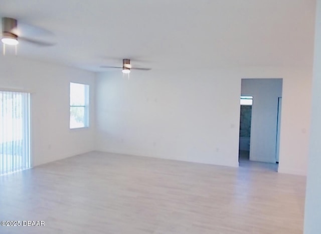 unfurnished room featuring light wood-type flooring and ceiling fan