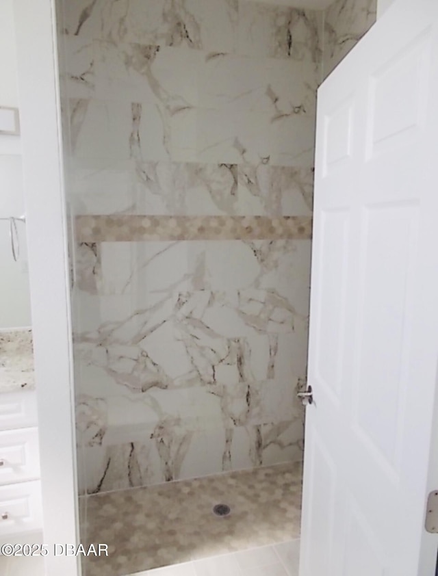 full bath featuring a marble finish shower