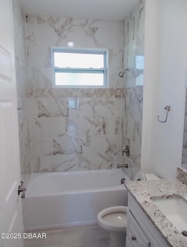 bathroom featuring toilet, bathing tub / shower combination, and vanity