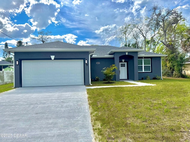 single story home with a garage, concrete driveway, fence, a front lawn, and stucco siding