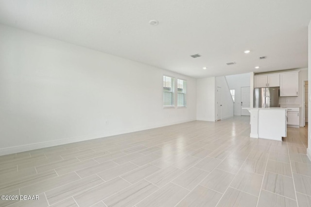 288 Links Terrace Blvd, Daytona Beach, FL 32124 - unfurnished living room with recessed lighting and baseboards