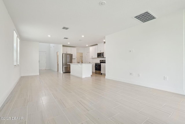 288 Links Terrace Blvd, Daytona Beach, FL 32124 - unfurnished living room with baseboards and recessed lighting
