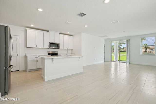 288 Links Terrace Blvd, Daytona Beach, FL 32124 - kitchen with stainless steel appliances, open floor plan, light countertops, white cabinets, and recessed lighting