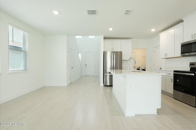 288 Links Terrace Blvd, Daytona Beach, FL 32124 - kitchen featuring stainless steel appliances, light countertops, a center island with sink, white cabinetry, and recessed lighting