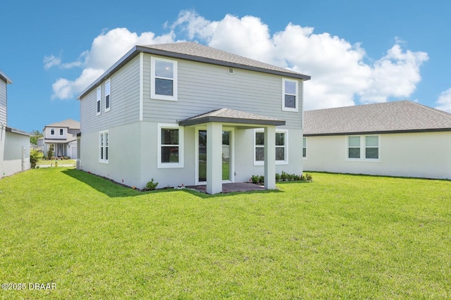 288 Links Terrace Blvd, Daytona Beach, FL 32124 - back of property with a yard, roof with shingles, and a patio