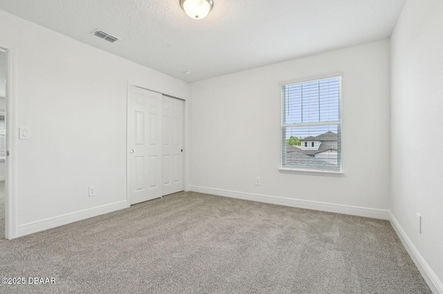 288 Links Terrace Blvd, Daytona Beach, FL 32124 - unfurnished bedroom featuring carpet, a closet, and a textured ceiling