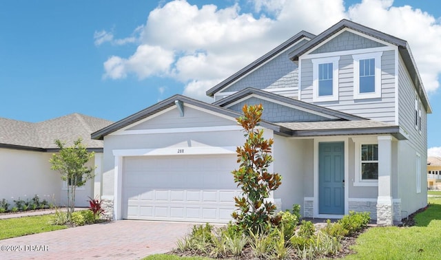 288 Links Terrace Blvd, Daytona Beach, FL 32124 - craftsman inspired home featuring decorative driveway, a garage, stone siding, and roof with shingles