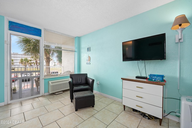 sitting room with a textured ceiling and light tile patterned floors