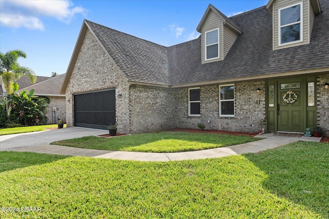 view of front of house featuring a garage and a front lawn