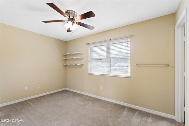 carpeted empty room with ceiling fan