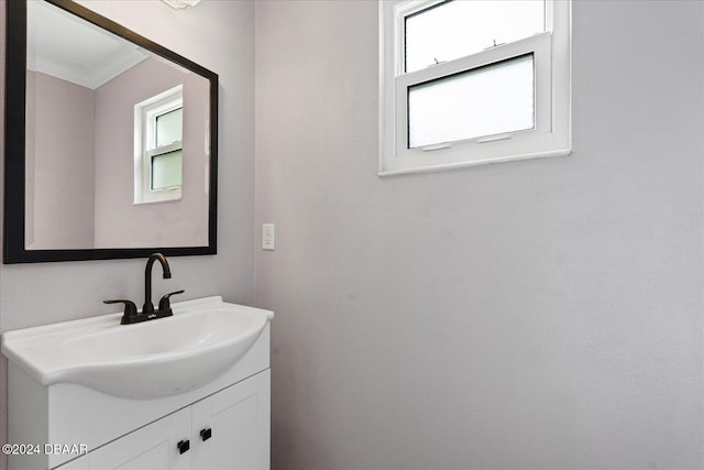 bathroom featuring vanity and ornamental molding