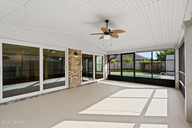 unfurnished sunroom with ceiling fan and lofted ceiling