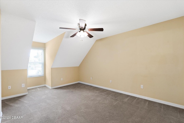 additional living space with a textured ceiling, ceiling fan, light colored carpet, and lofted ceiling