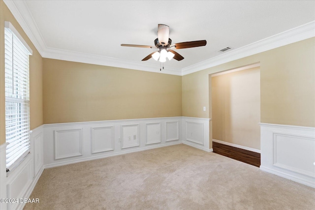 carpeted empty room featuring ceiling fan and ornamental molding