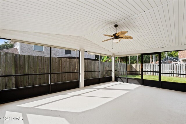 unfurnished sunroom featuring vaulted ceiling and ceiling fan