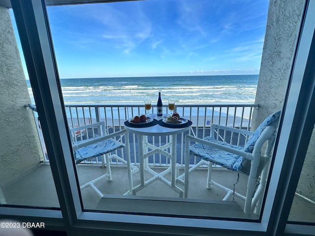 balcony with a view of the beach and a water view