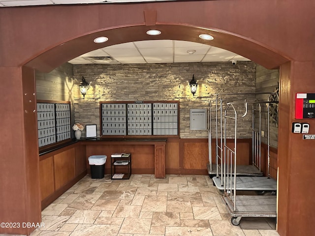 interior space with a mail area and wooden walls